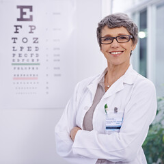 Woman, senior optometrist and arms crossed for eye care in portrait, test and alphabet chart for...