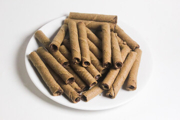 some chocolate wafer rolls on a plate