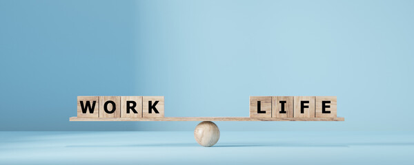 Work life balance concept. Wooden cube block with word WORK and LIFE on seesaw.