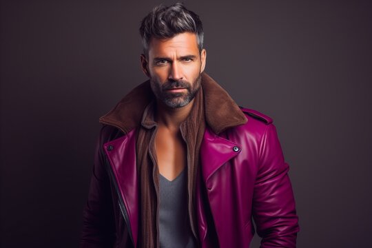 Portrait of a handsome bearded man in a leather jacket. Men's beauty, fashion.