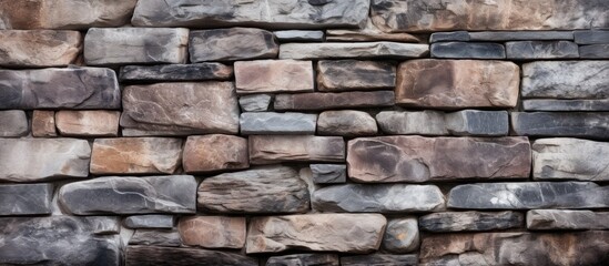 A detailed closeup photo showcasing a diverse mix of brown bricks in a brick wall. The combination of different types of bricks creates a unique and varied texture