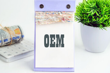 OEM original equipment manufacturer concept. Text on a piece of a desktop calendar with tear-off pages