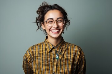 Portrait of a beautiful young woman in glasses and plaid shirt
