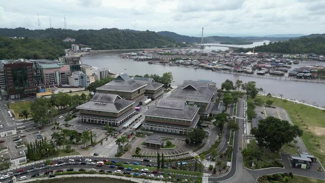 aerial drone shot leaving the urban center over the river towards the floating villages of Kampong Ayer in Bandar Seri Bagawan in Brunei Darussalam
