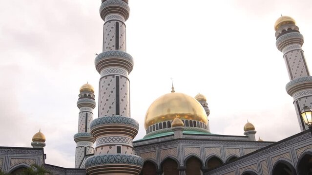 looking up through the palm trees at Jame' Asr Hassanil Bolkiah Mosque in Bandar Seri Bagawan in Brunei Darussalam