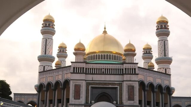 Peering through the arched doorway towards Jame' Asr Hassanil Bolkiah Mosque in Bandar Seri Bagawan in Brunei Darussalam at sunset
