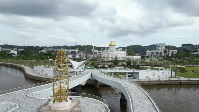 aerial drone shot of pedestrian bridge leading towards Sultan Omar Ali Saifuddien Mosque in Bandar Seri Bagawan in Brunei Darussalam
