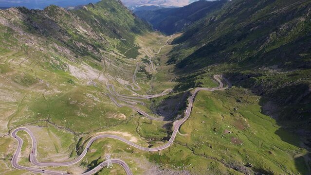 The winding transfagarasan road in fagaras mountains, romania, on a sunny day, aerial view