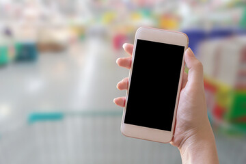 Hand holding smart phone with blur background