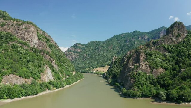 The olt river winding through the lush carpathian mountains, aerial view