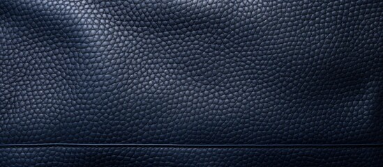 A closeup of a dark blue leather texture resembling carbon pattern, with electric blue tones and a sleek grillelike metal mesh design, creating a symmetrical and modern look