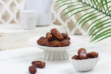 Kurma or Dates fruit on marble white background. Breakfasting concept in Ramadan month. Islamic template for text background.