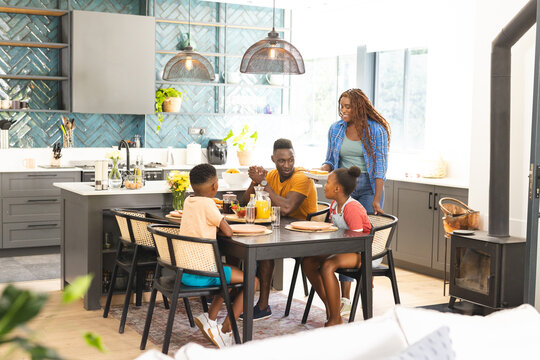 A young African American family enjoys a breakfast together at home