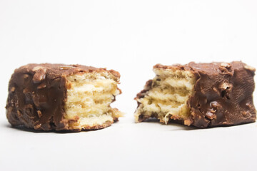 a snack of caramel chocolate wafers cut in half, on a white background