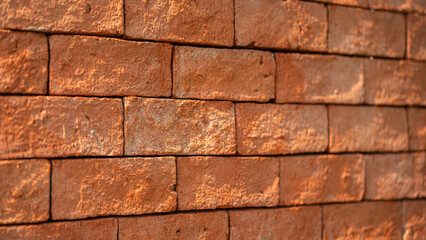 Clay brick block wall with roughly surface, close-up and selective focus. background and texture.