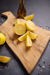 Naklejka na ściany i meble Sliced lemon fruit on a wooden cutting board at domestic kitchen