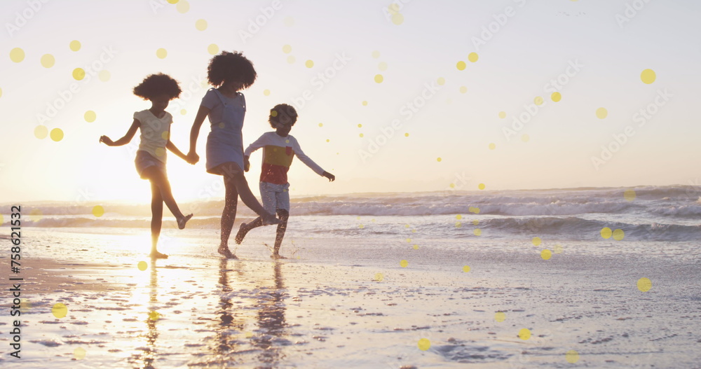 Sticker Image of spots over happy african american mother with children on sunny beach