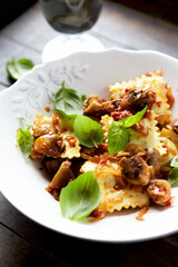 Ravioli with mushrooms and fresh basil. Dark wooden background. Close up	