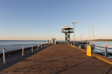 Tourists enjoying the evening views of the Pacific Ocean and the city of Port Angeles from the famous observation tower on the pier