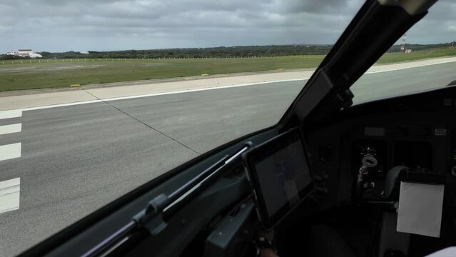 Airport runway view from inside a jet cocpit aligning ready for takeoff. Immersive pilot POV. 4K. Clouded sky, daylight.
