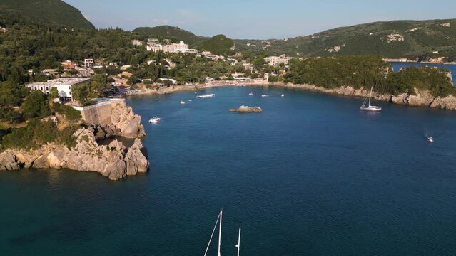 Drone fly above sailboat anchored in bay of Corfu Greece on sunny calm afternoon