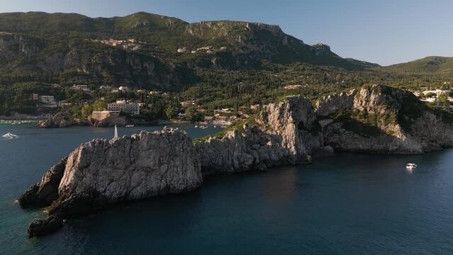 Panoramic aerial dolly above cape in Corfu Greece with dramatic shadows and light on landscape