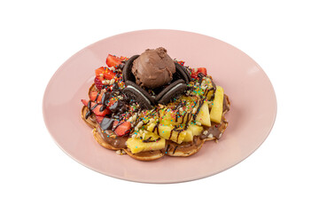 Heart waffle with pineapple and strawberry with gummy candy and ice cream on it