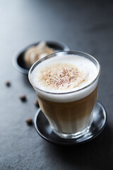 Coffee with milk on dark stone background. Close up.	