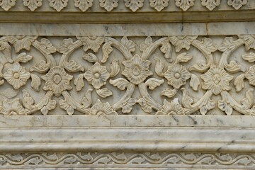 Intricately Carved Stone Frieze on medieval  cenotaph Wall in Broad Daylight at maharani ki chhatri Jaipur, Rajasthan, India 
