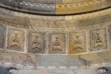  Intricately Carved Stone Frieze on medieval cenotaph Wall in Broad Daylight at maharani ki chhatri Jaipur, Rajasthan, India