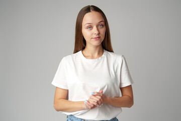 Young woman in blue t-shirt looking at camera with serious expression