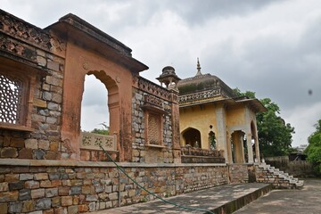 Obraz premium Majestic Royal Cenotaphs Amidst Verdant Greenery Under Cloudy Skies at Maharani Ki Chhatri ,Jaipur, Rajasthan, India