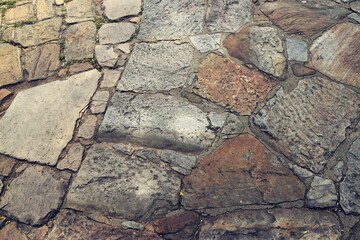 An elegant stone walkway featuring cobblestones, highlighting a captivating stone floor design.
