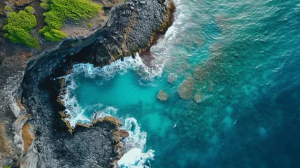 Foto op Canvas Aerial view of a natural rock pool along the coastline with waves breaking on the cliffs © Hassan