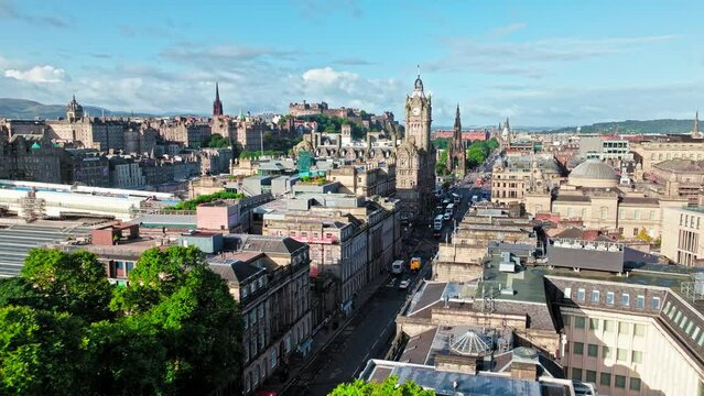 Aerial view of 5-star hotel, city view of old buildings in Edinburgh, Scotland. Luxury hotel and landmark clock tower, a symbol of its city. Victorian architecture in Scotland.