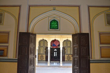 Fototapeta na wymiar A sequence of intricately designed arched doorways open to a tranquil courtyard, Nahargarh Fort, Jaipur, Rajasthan, India 