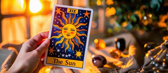 The Sun Tarot Card Displayed with Warm Bokeh Background - obrazy, fototapety, plakaty