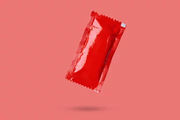 Foto op Aluminium Blank red foil tomato ketchup sauce sachet package float on red background © Piman Khrutmuang
