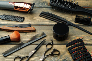 Set of professional barber tools on wooden table