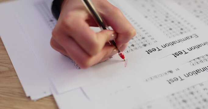 Female grades student test with A and plus with red pen