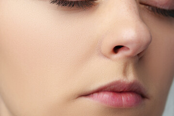 Close up of a young woman with nude make up