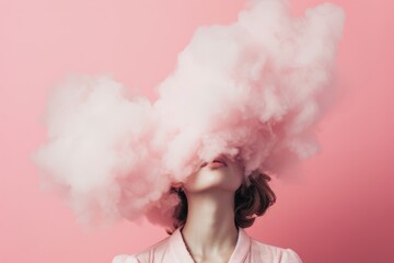  young woman with her covered in the pink cloud on a pastel pink background