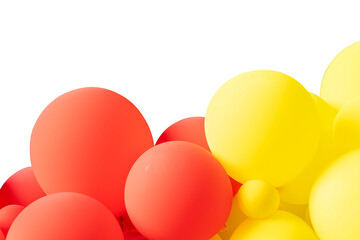 A bunch of red and yellow balloons floating on a white background. The balloons are of different...