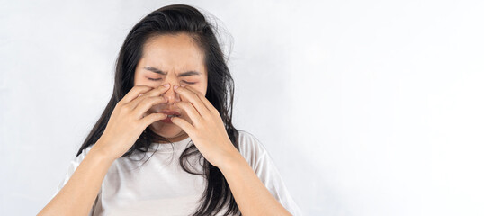 An Asian woman has a pain in nose or sinusitis, sinus infection, pain concept.