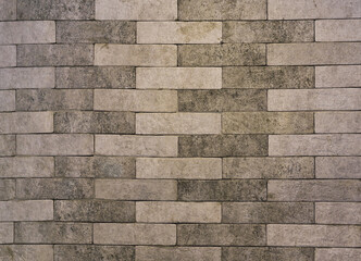 The background is a gray brick wall. textured brick backdrop