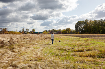 Owner walking with a dog on nature. Friendship of a dog and a woman