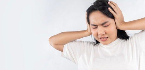 Tinnitus concept. Closeup side profile sick young woman having ear pain touching her painful head.