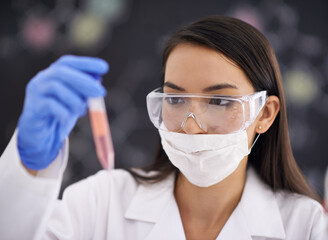 Scientist, test tube and woman in mask for research, experiment and cure. Science, glasses and medical professional with vial for chemistry, study and check liquid sample for laboratory analysis