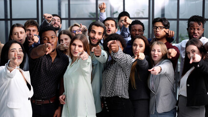 Large group of young people pointing at you.