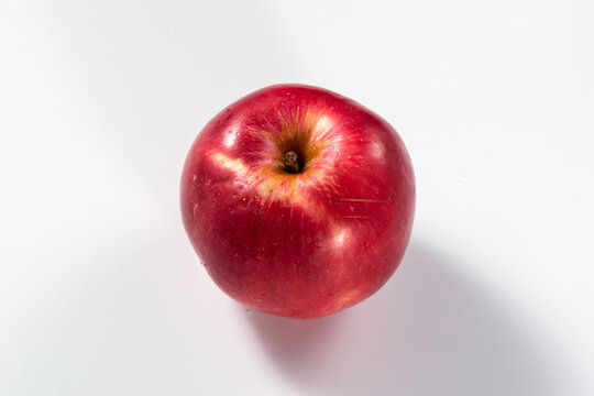 Isolated single red apple on a white background. View from above at an angle